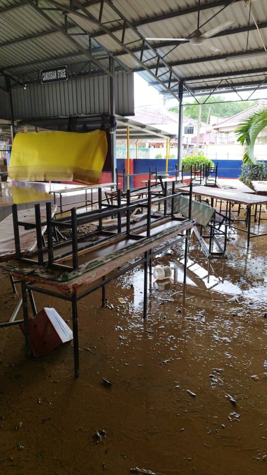 School canteen in a state of mess with fallen tables after the flood